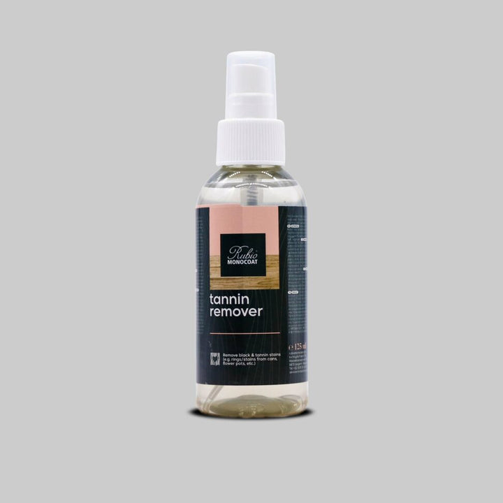 Bottle of Rubio wood floor tannin remover with a white spray cap on a grey background
