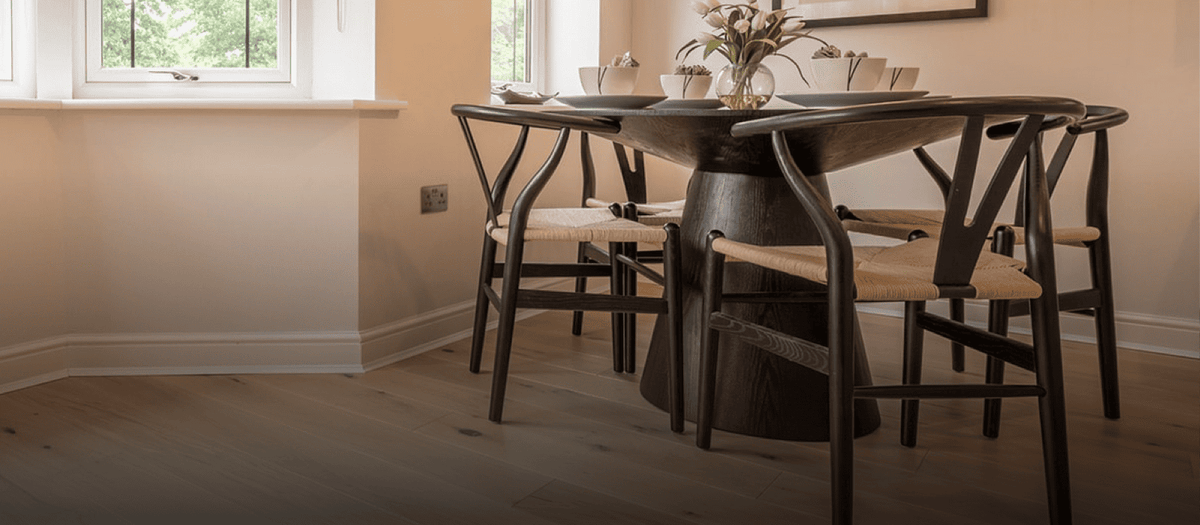 a dining space with engineered wood flooring
